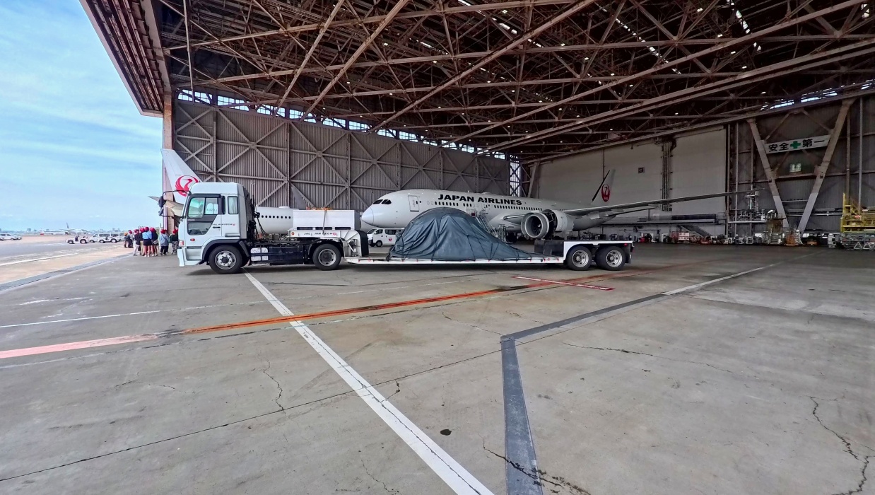 エンジンが羽田の整備場で点検され、成田空港へ運ばれる。